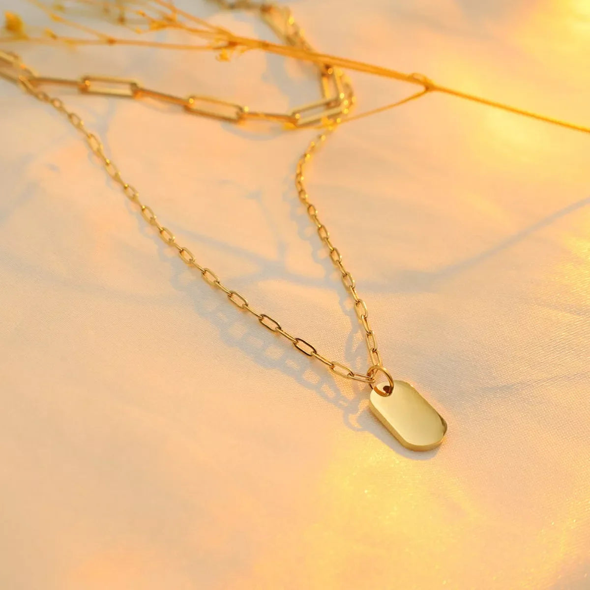 Elegant 18K gold-plated double layered necklace with intricate chain design, perfect for stylish accessories.