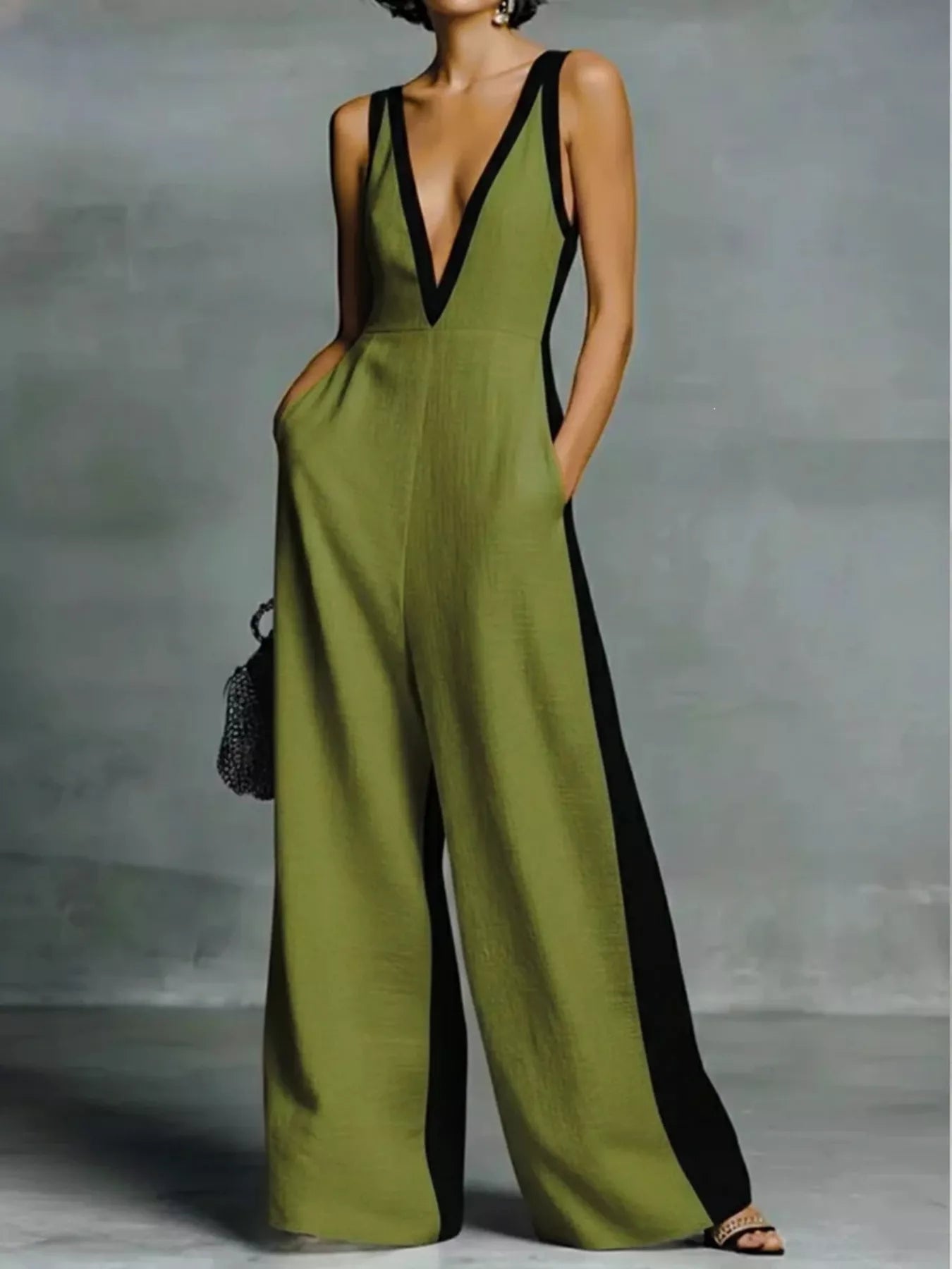 Deep V-neck wide-leg jumpsuit by Trendsi, featuring a stylish onesie design with a flattering fit and flowing wide-leg silhouette.