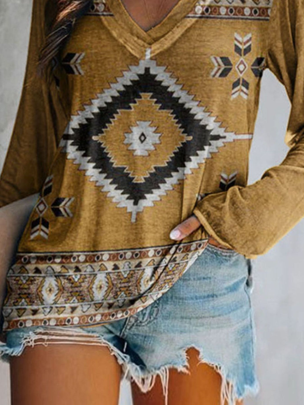 Plus size geometric print V-neck long sleeve T-shirt from Trendsi featuring a comfortable casual fit and stylish design.