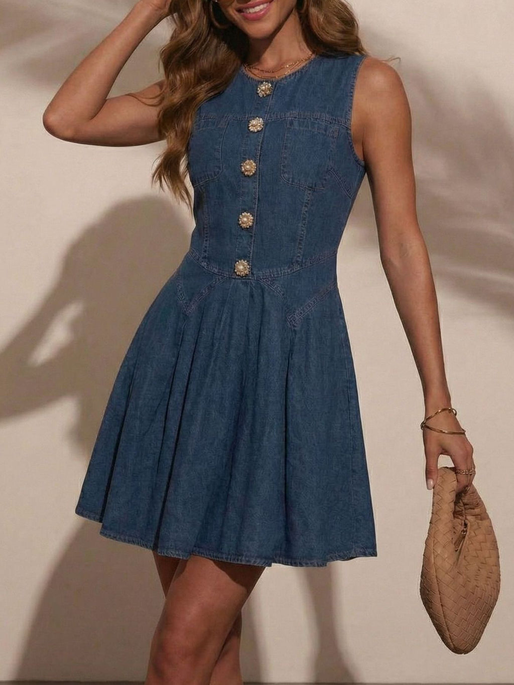 Women's sleeveless button-front denim mini dress by Trendsi, made of stretchy cotton blend fabric, shown on model.