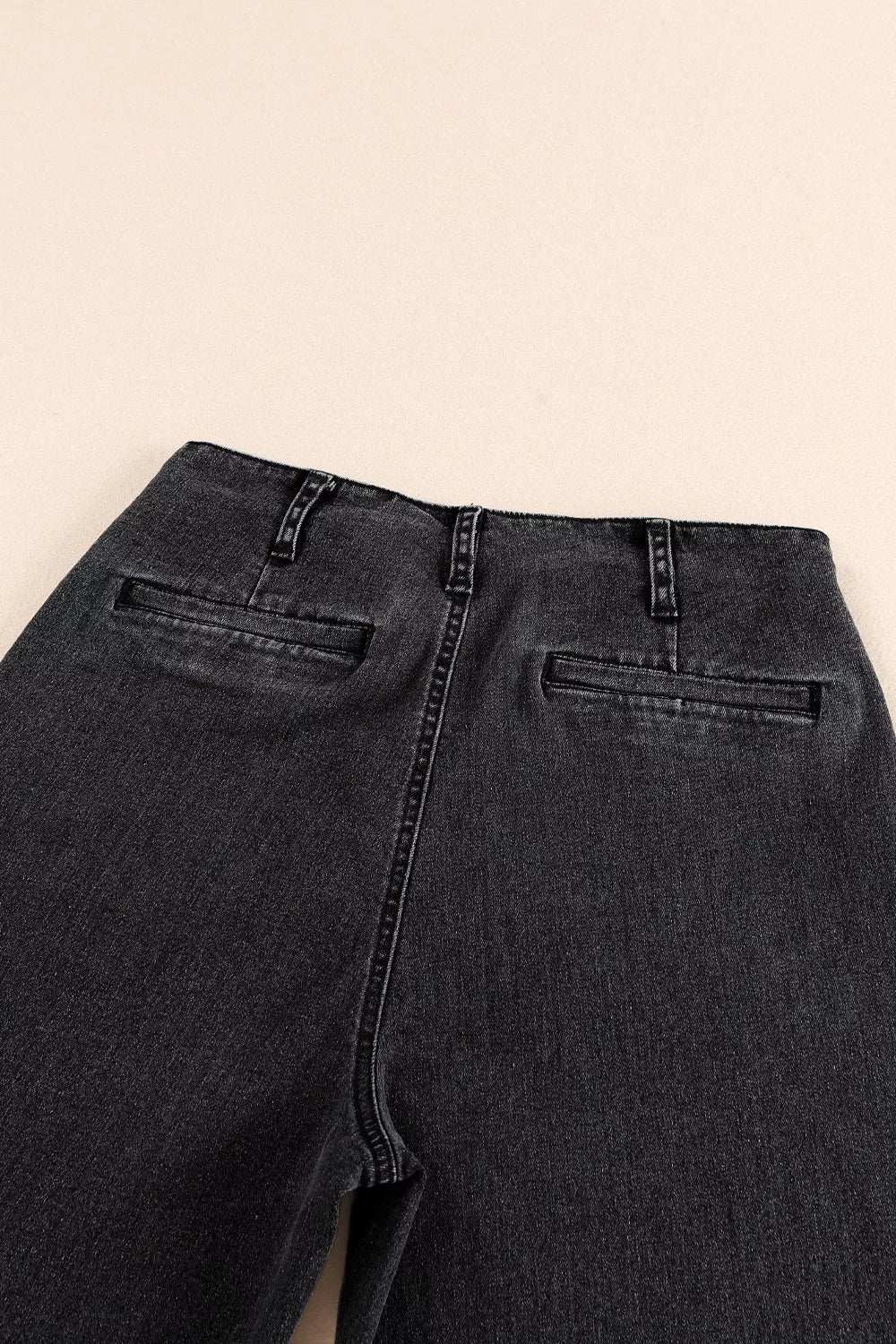 High-waisted button-fly wide-leg jeans by Trendsi, showcasing classic denim with a relaxed fit and stylish wide-leg silhouette.