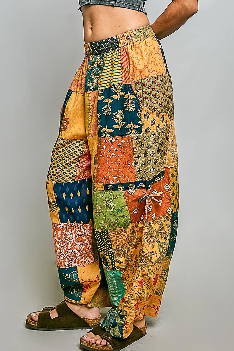Printed patchwork wide-leg cotton pants with side drawstring, styled as a casual dress, showcasing colorful fabric and relaxed fit.