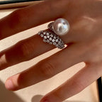 925 sterling silver pearl bypass ring with smooth band and pearl accents, showcasing elegant jewelry design.
