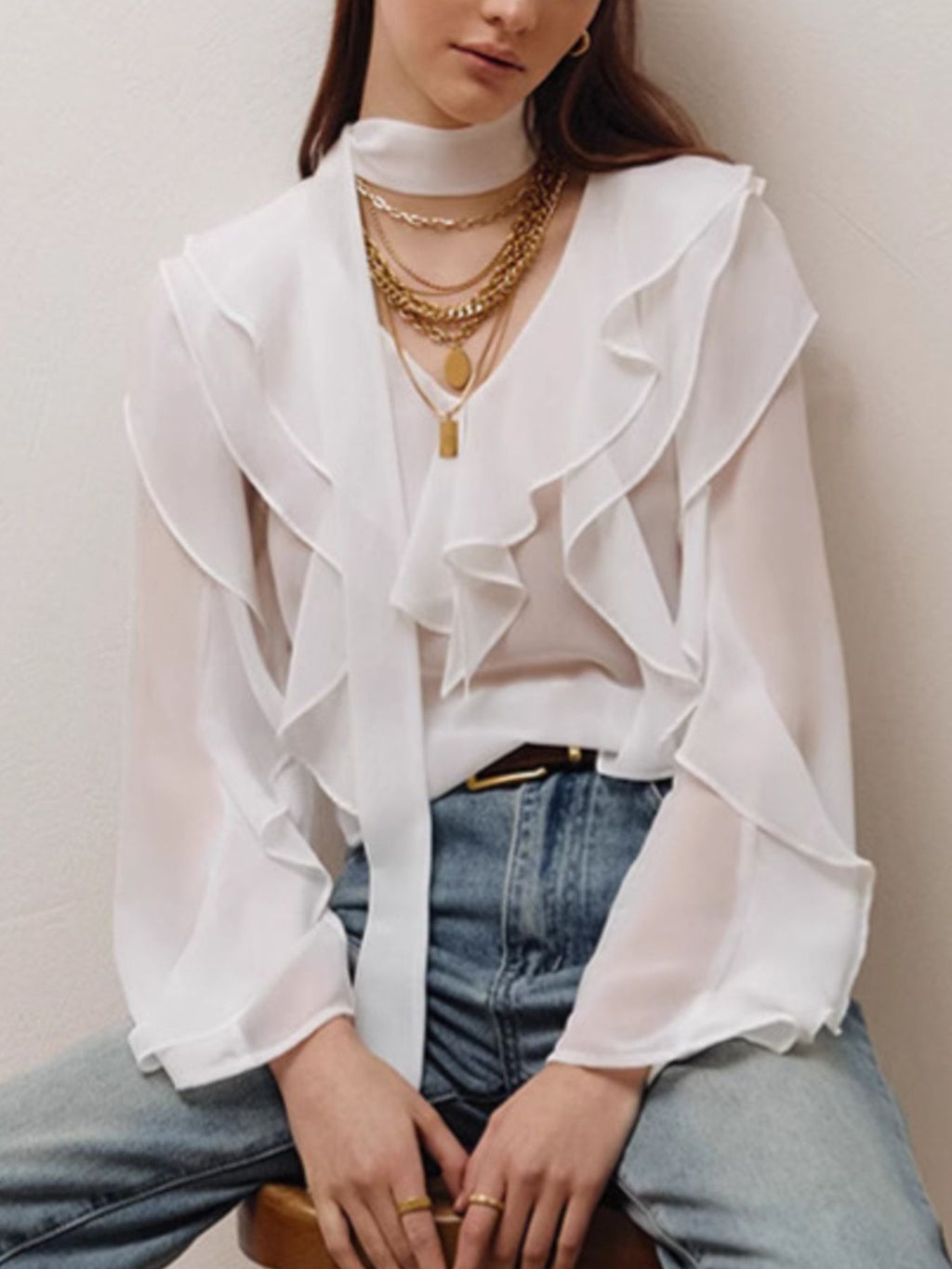 Elegant chiffon blouse with ruffle trim and tie neck detail, featuring a flowy fabric and feminine design.