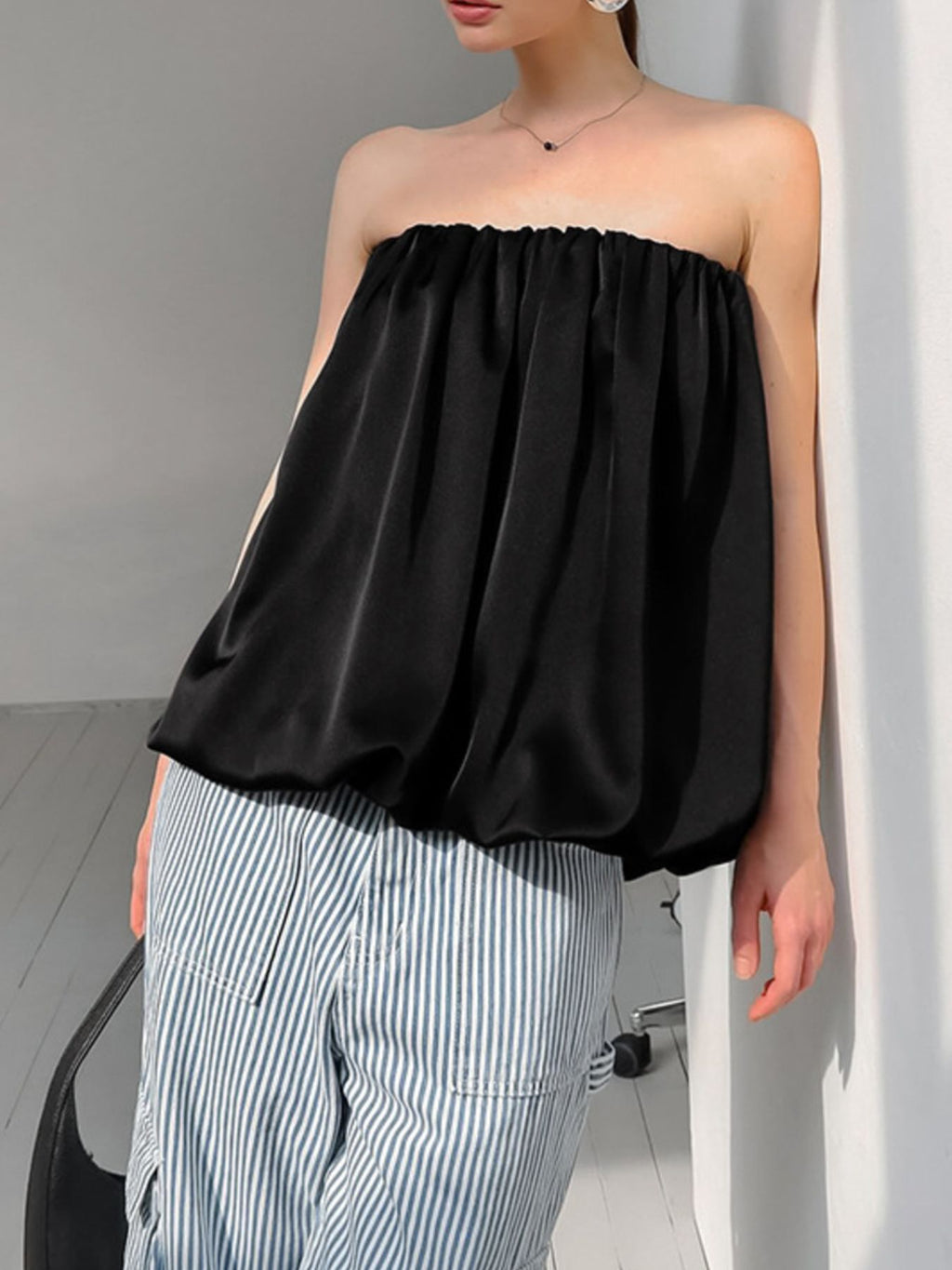 Women's strapless bubble hem tube top by Plush Fashion Hub, featuring a sleek, minimalist design and trendy crop style.