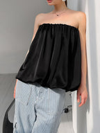 Women's strapless bubble hem tube top by Plush Fashion Hub, featuring a sleek, minimalist design and trendy crop style.