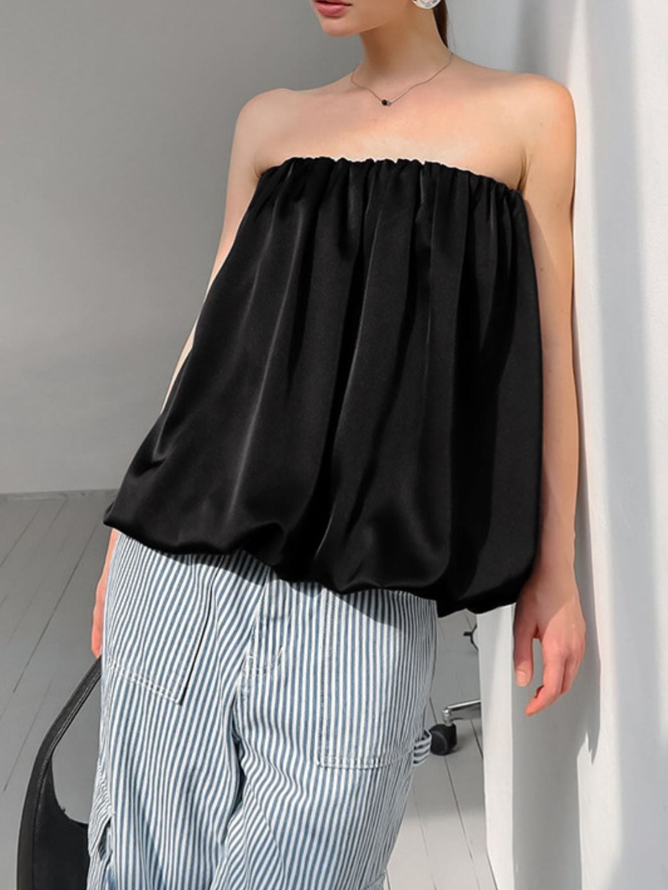 Women's strapless bubble hem tube top by Plush Fashion Hub, featuring a sleek, minimalist design and trendy crop style.