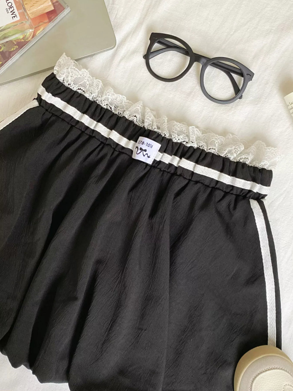 Lace trim elastic waist mini skirt in soft fabric with stylish design, perfect for casual or dressy occasions.
