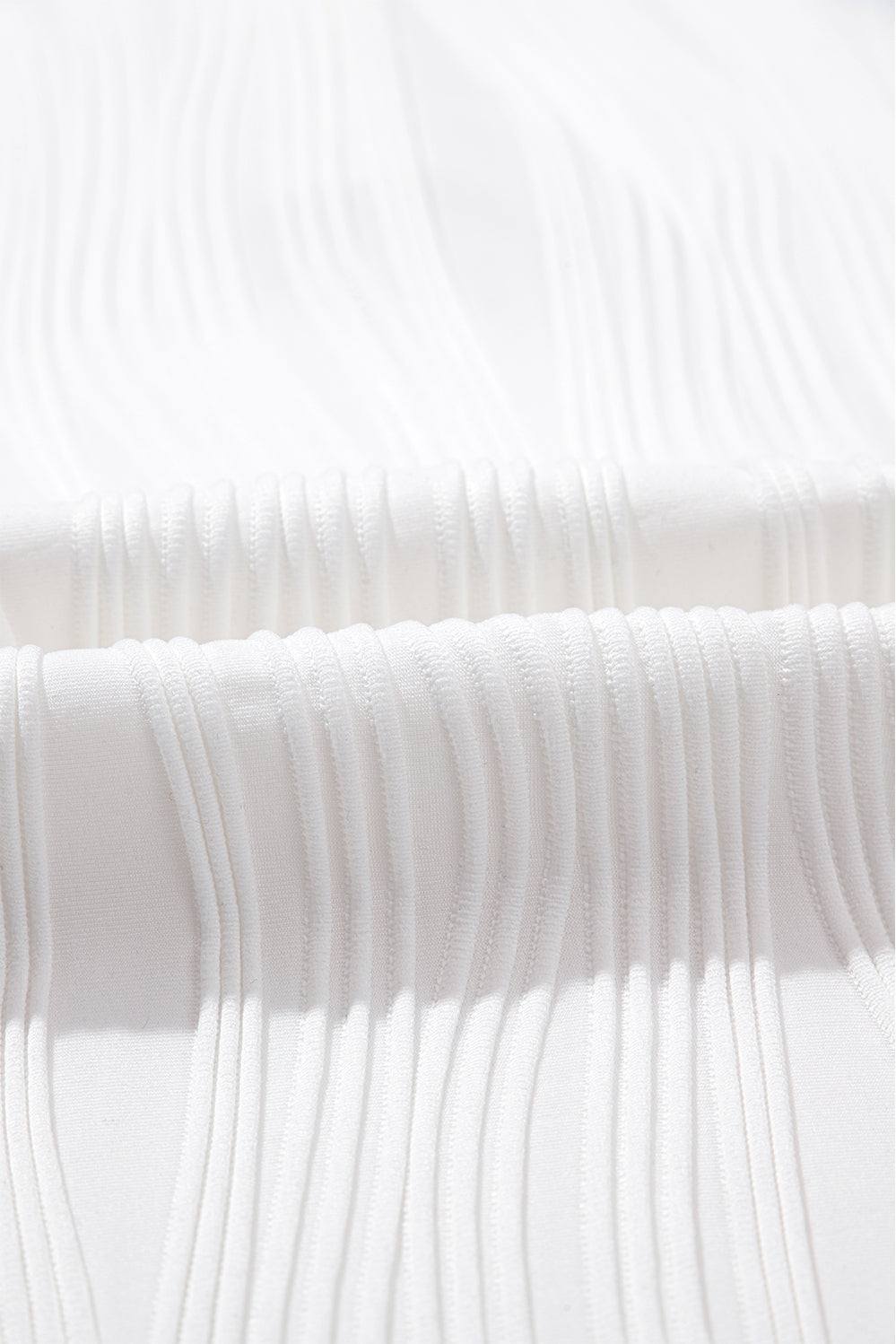 Wavy textured Raina Tee by Threaded Pear, stylish casual top with a relaxed fit and unique fabric texture.