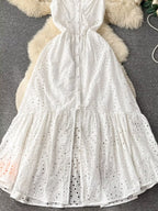 Eyelet embroidered tiered boho camisole dress with summer midi length, featuring lightweight fabric and relaxed fit.