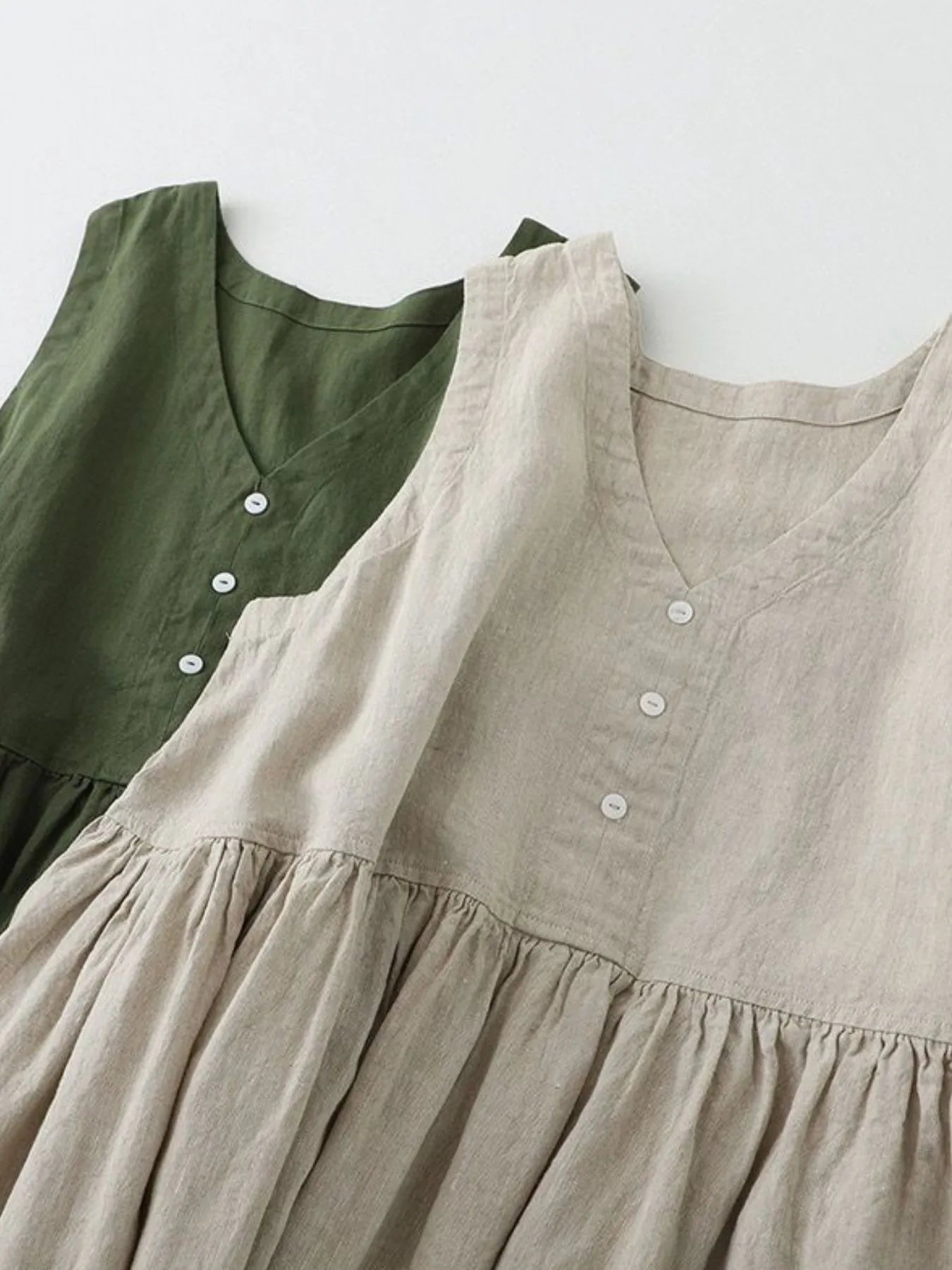 Women's sleeveless V-neck midi dress by Trendsi, made of 100% cotton with button details, casual and comfortable.
