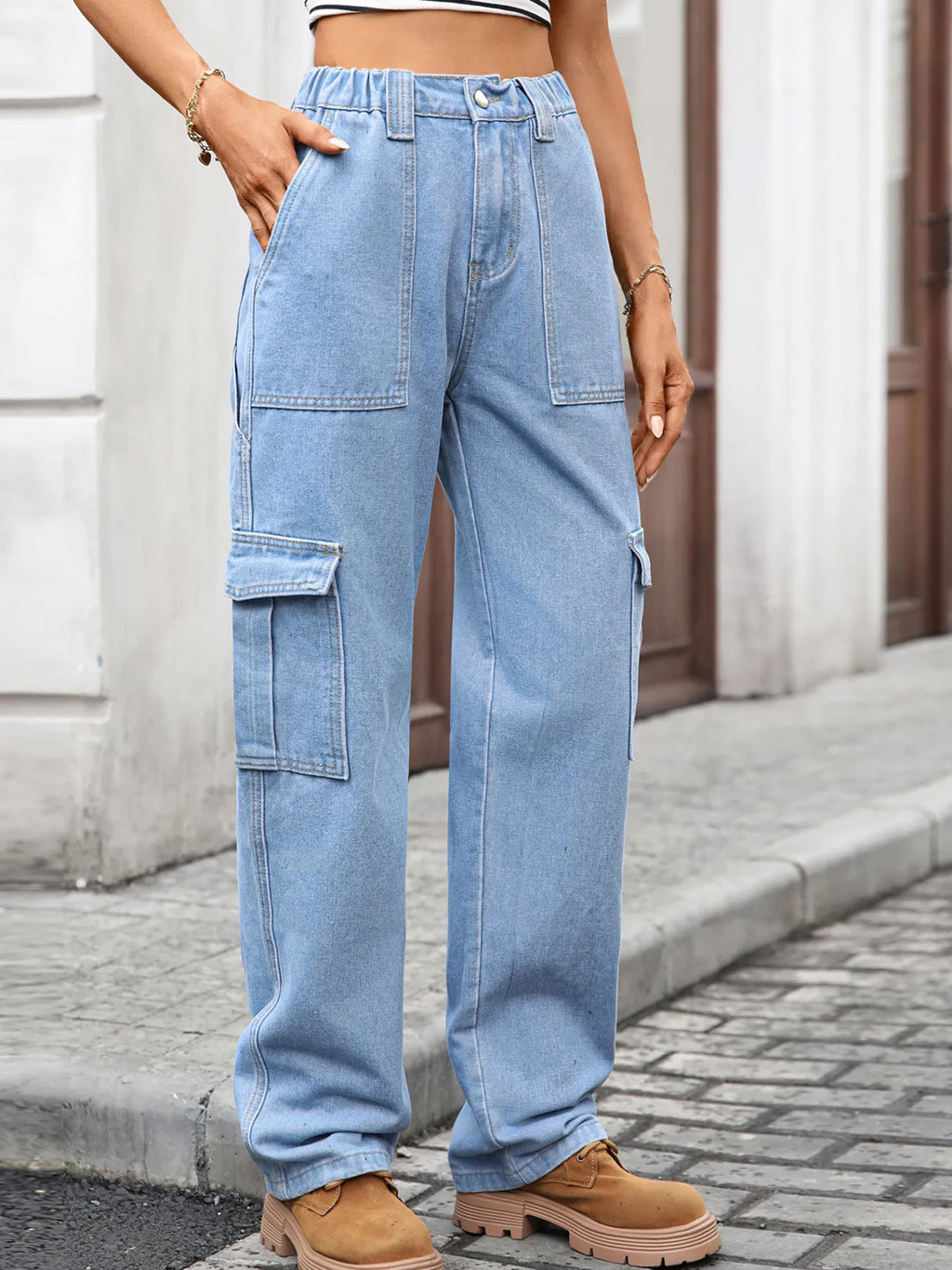High-waisted plush fashion denim cargo jeans with multiple pockets and relaxed fit, shown on a model.