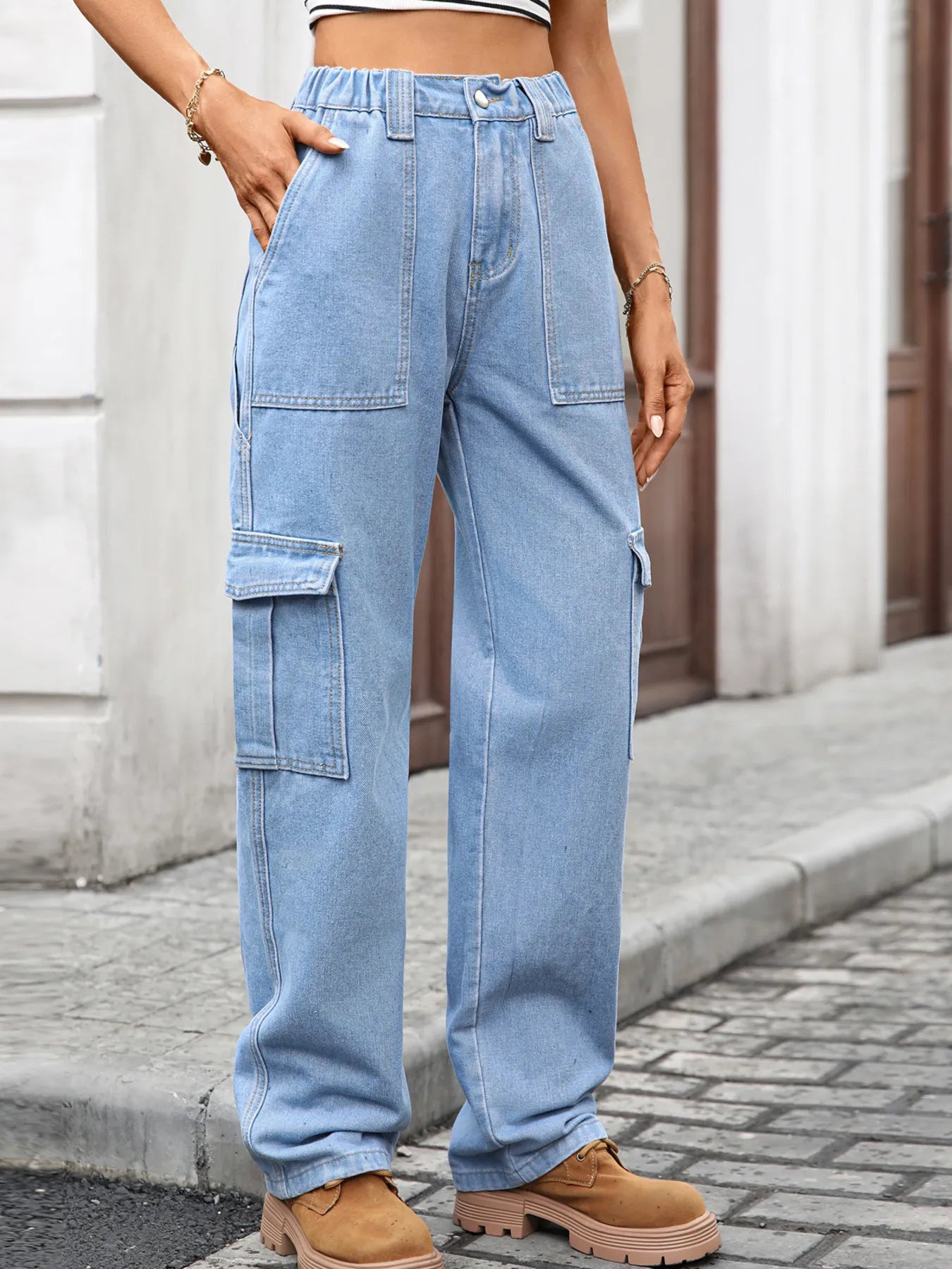 High-waisted plush fashion denim cargo jeans with multiple pockets and relaxed fit, shown on a model.