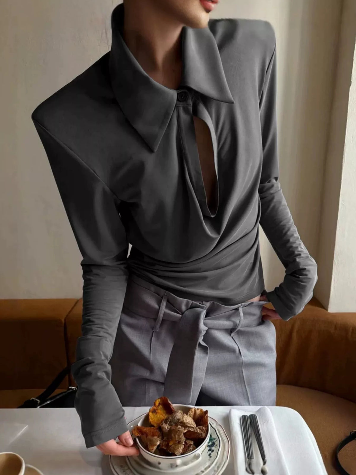 Slim-fit long-sleeve T-shirt with cutout detail from Trendsi, shown in black with sleek design and fitted silhouette.