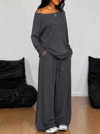 Plus size loose fit one-shoulder T-shirt and pants set by Trendsi, featuring comfortable, relaxed fit pants in the image.