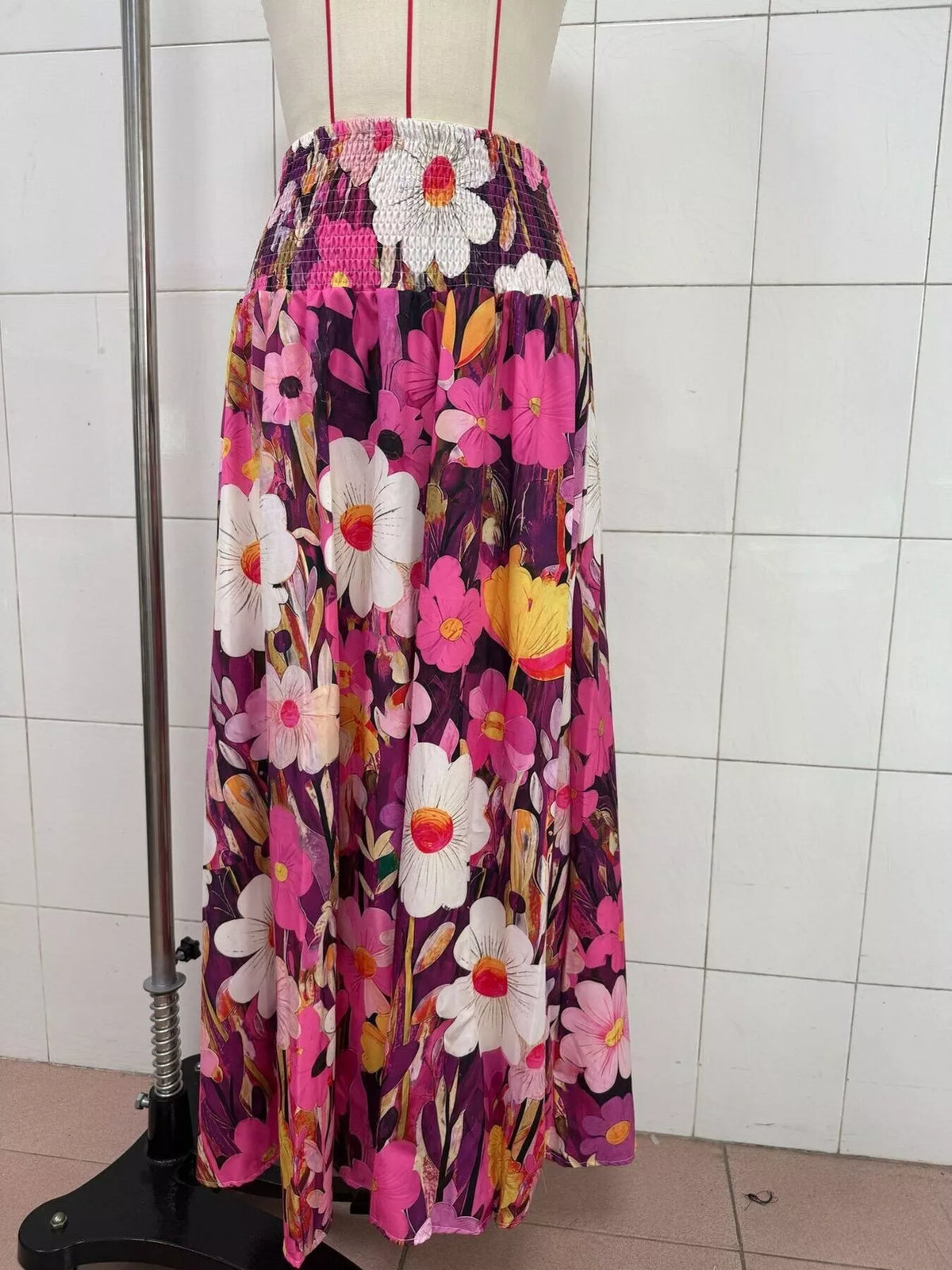 Floral print high-waisted maxi skirt from Trendsi showcasing a flowing design and vibrant floral pattern.