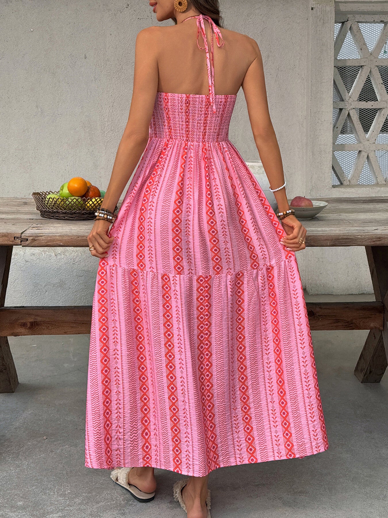 Printed halter neck smocked midi dress with side slit, stylish Trendsi dress featuring a fitted bodice and flowy skirt.