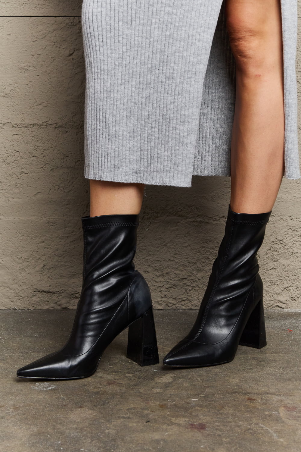 Weeboo Stacy block heel sock boots by Trendsi featuring black fabric with a sleek, modern design and comfortable ankle height.