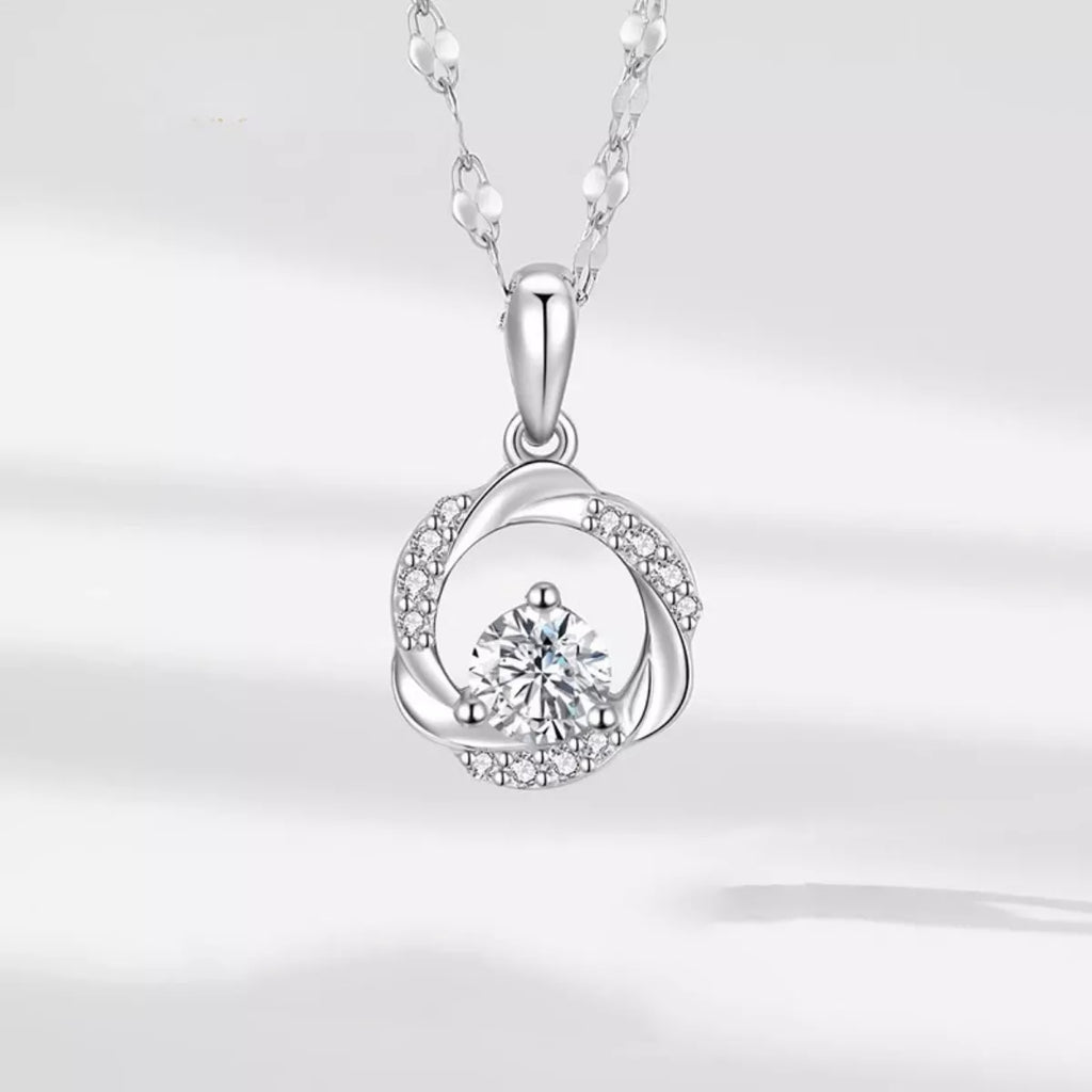 Sterling silver zircon pendant necklace with a sparkling gemstone, featuring a delicate chain and elegant design.