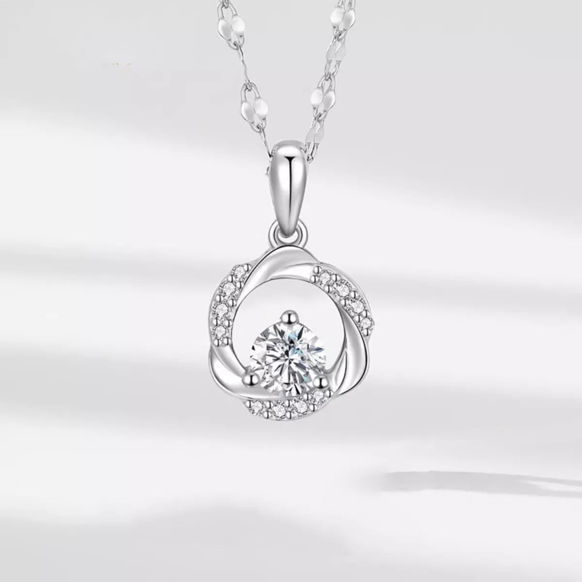 Sterling silver zircon pendant necklace with a sparkling gemstone, featuring a delicate chain and elegant design.