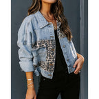 Women's cropped distressed denim jacket by FitiqueFit, displayed on a hanger, showcasing its casualwear style and frayed edges.