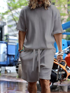 Men's plus size short sleeve top and shorts set by Trendsi, casual summer outfit, lightweight fabric, vibrant color, front view.
