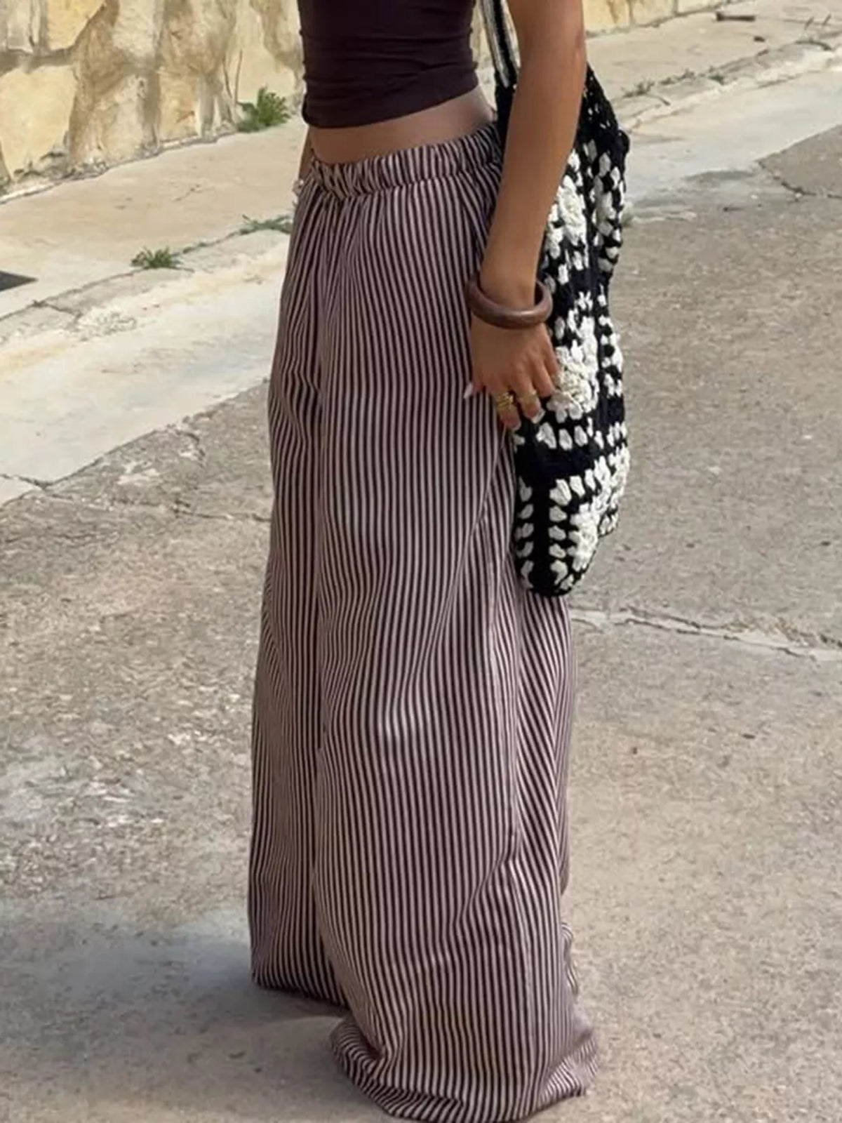 Plush Fashion Hub tied striped wide-leg pants, stylish bottoms with a relaxed fit and bold stripe pattern.
