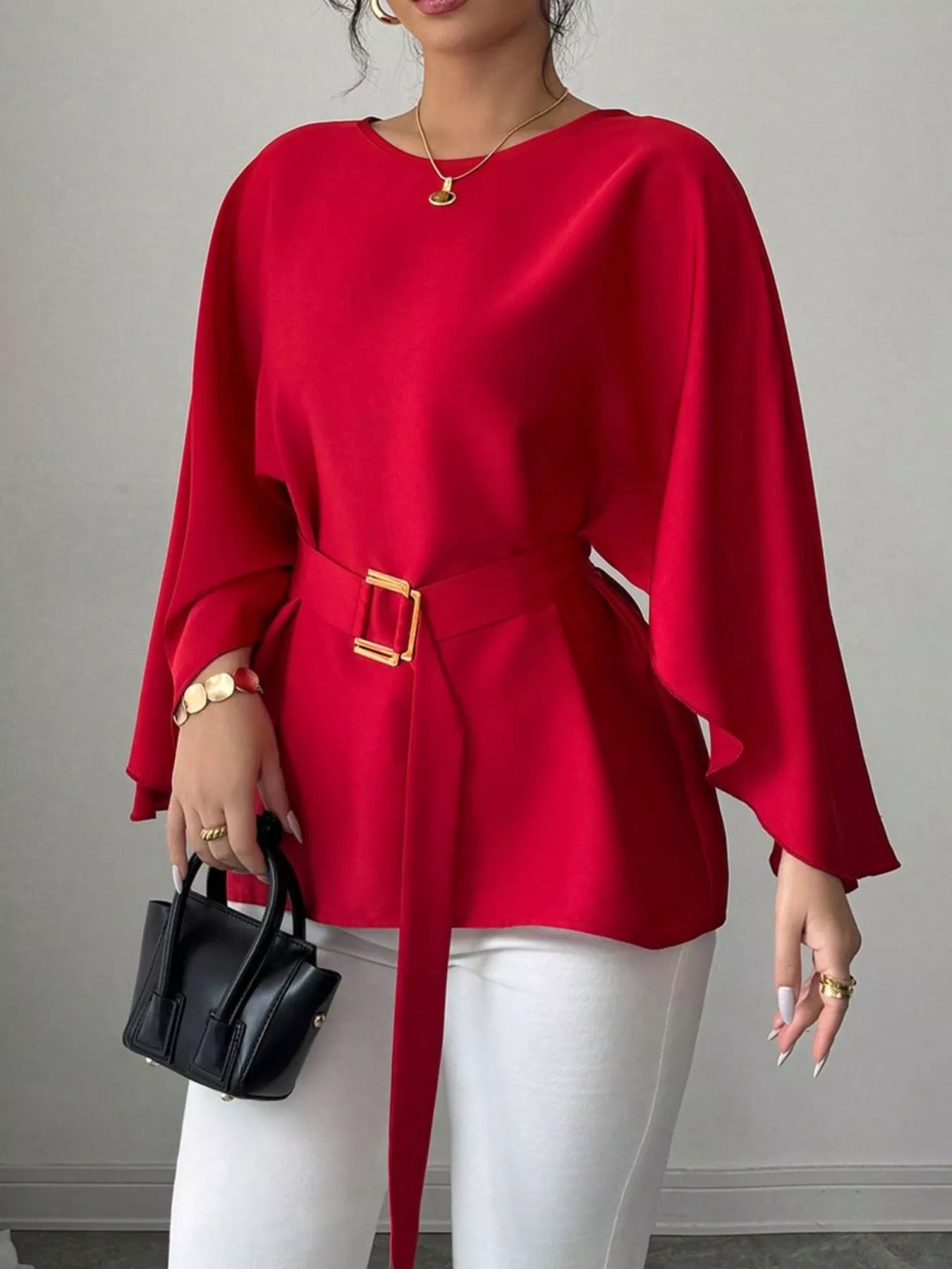 Black batwing sleeve belted blouse by Shopimist, featuring flowing fabric and a waist belt, displayed on a hanger.