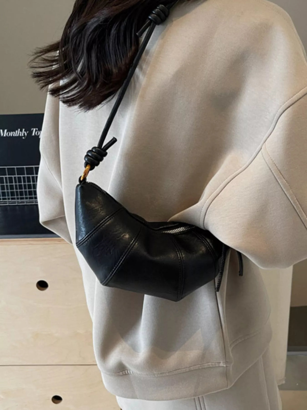 Plush Fashion Hub croissant-shaped plush crossbody bag with a soft, detailed texture and adjustable strap.