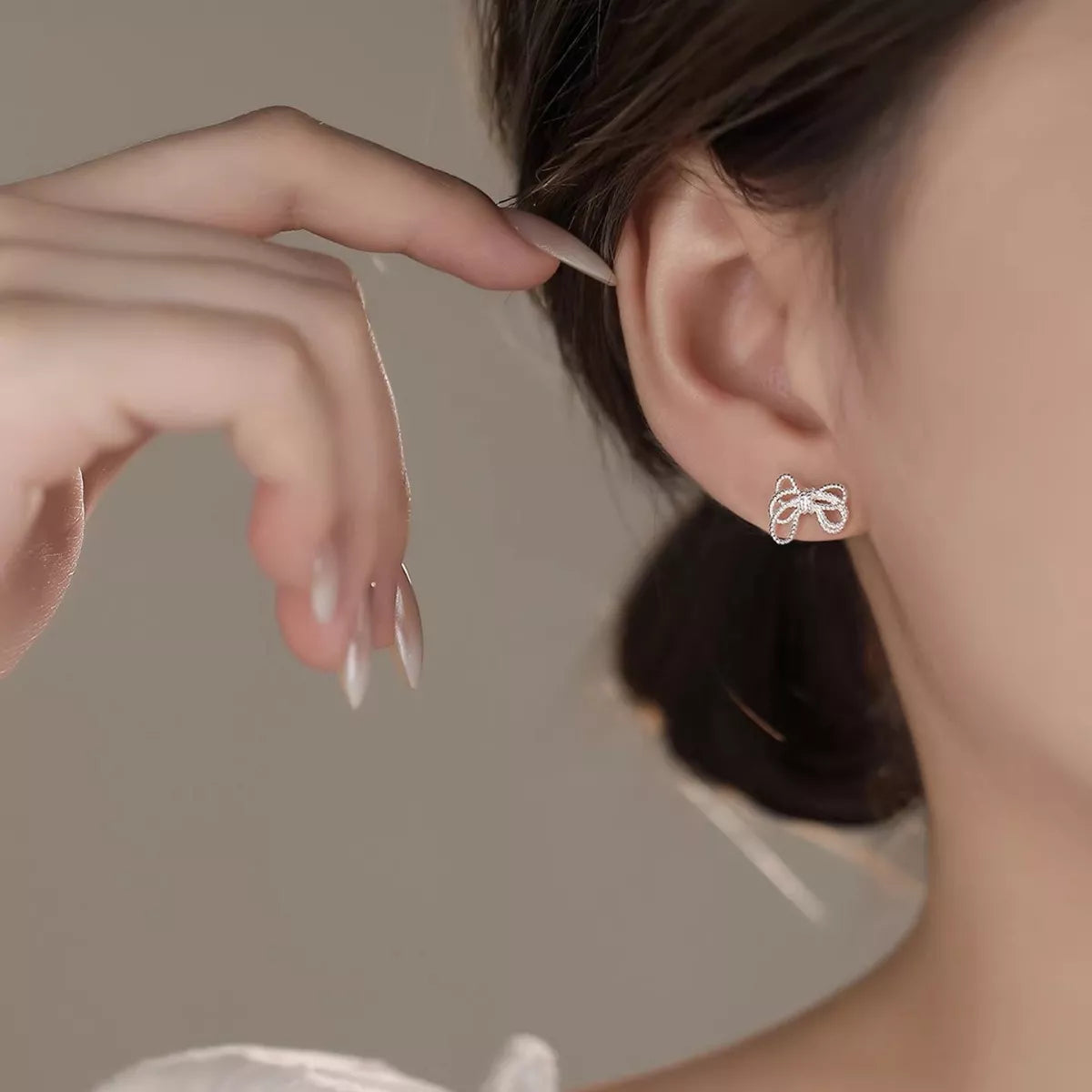 Sterling silver bow knot stud earrings with polished finish, stylish jewelry accessory for women, by Plush Fashion Hub