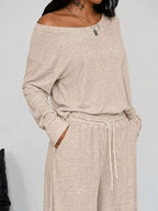 Plus size loose fit one-shoulder T-shirt and pants set by Trendsi, featuring comfortable, relaxed style and casual fashion.