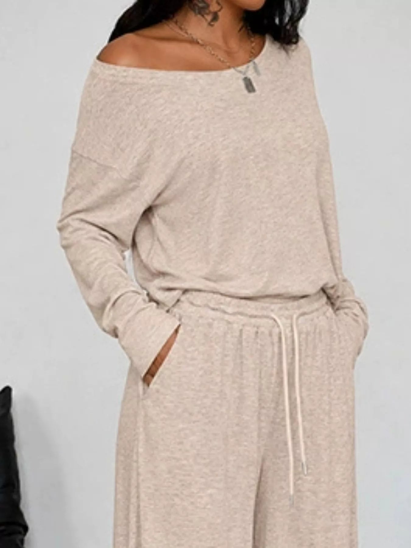 Plus size loose fit one-shoulder T-shirt and pants set by Trendsi, featuring comfortable, relaxed style and casual fashion.