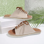 Women's lace-up open toe flat sandals in faux leather, trendy slip-on shoes with stylish design and comfortable fit.