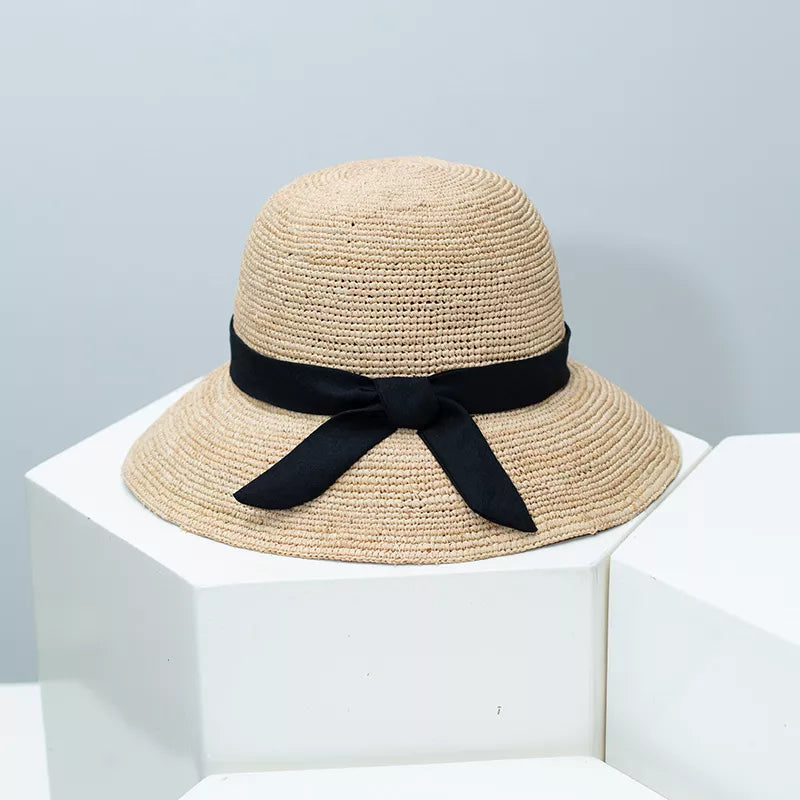 Women's straw sun hat with wide brim and ribbon detail, stylish summer accessory by Plush Fashion Hub.