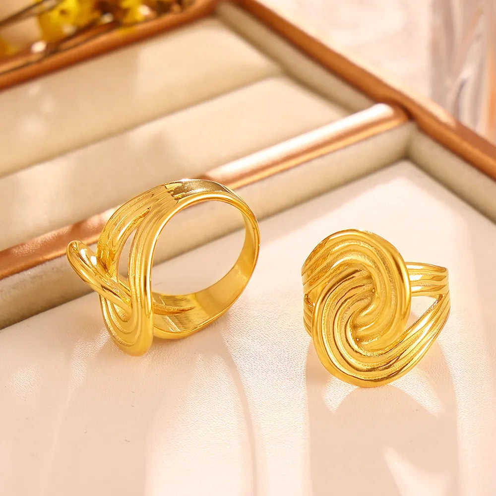 18K gold-plated twisted ring with a sleek, elegant design, showcasing its shiny, polished finish and intricate band details.