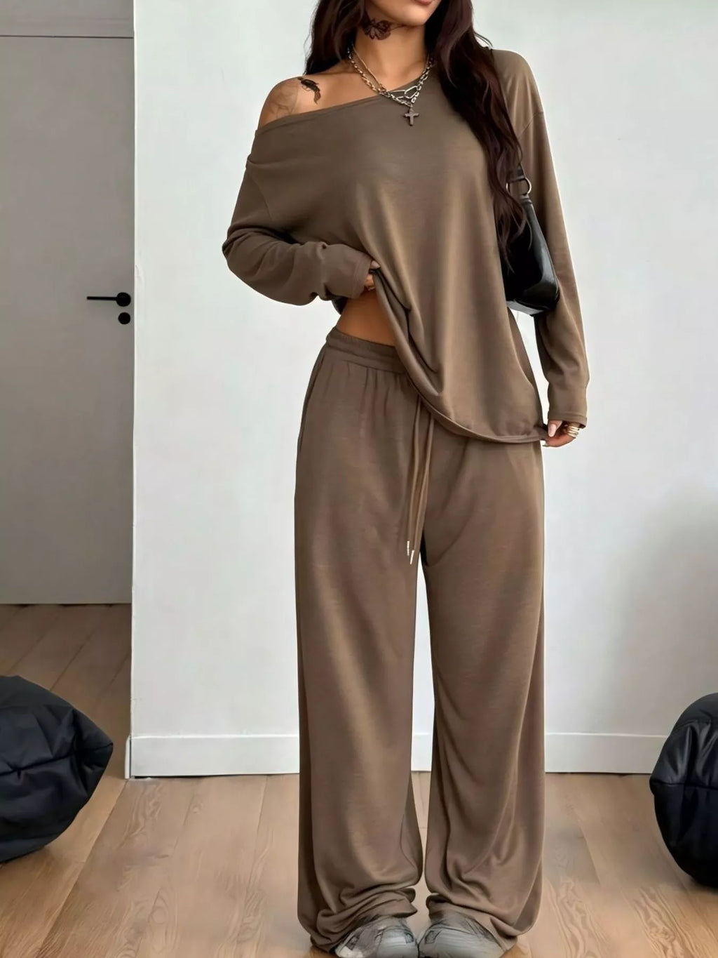 Plus size loose fit one-shoulder T-shirt and pants set by Trendsi, featuring comfortable, relaxed-fit fabric and stylish design.
