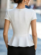Pearl-embellished peplum T-shirt from Shopimist featuring a fitted silhouette and decorative pearl accents on soft fabric.