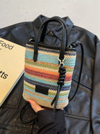 Striped woven mini crossbody bag by Trendsi featuring a compact design with adjustable strap and colorful striped pattern.