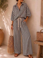 Plus size striped puff sleeve shirt and wide-leg drawstring pants set by Trendsi, showing the stylish matching outfit and fabric details.