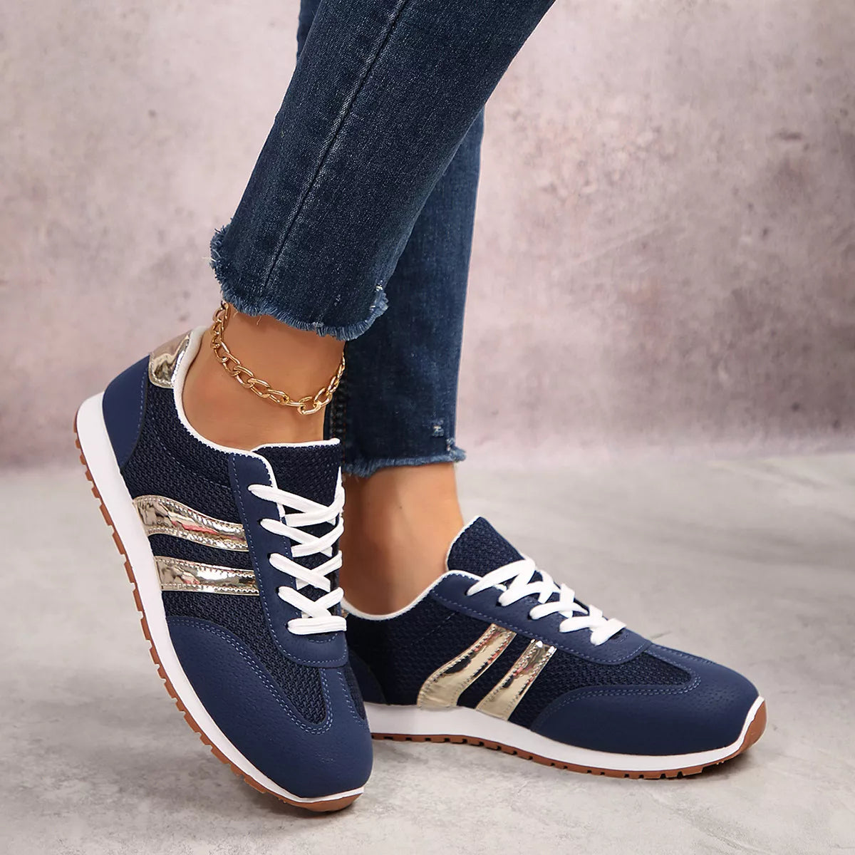 Women's round toe lace-up sneakers by Trendsi, featuring a stylish design and comfortable fit in a classic sneaker style.
