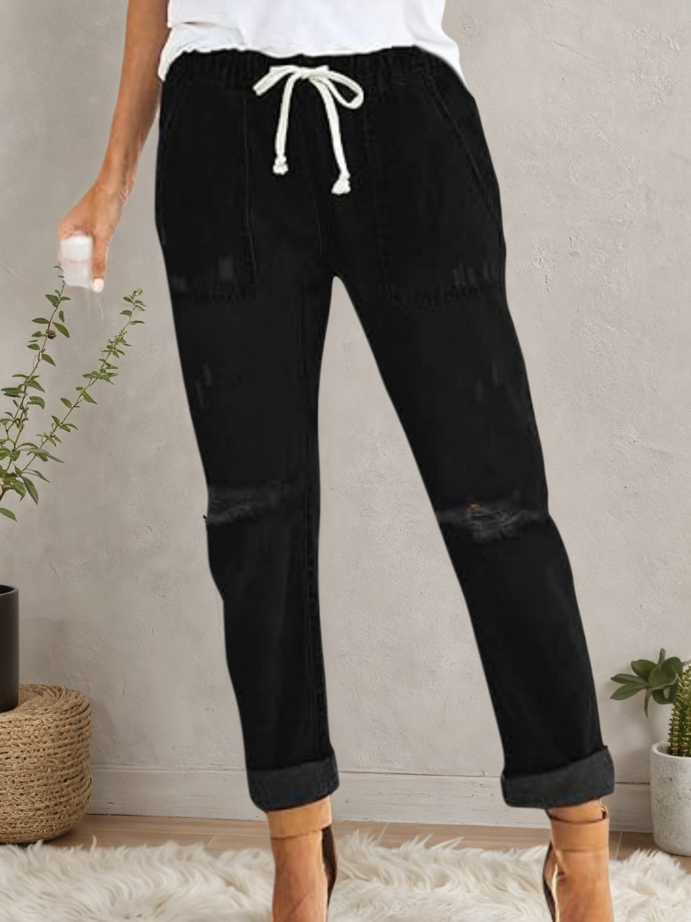 Women’s distressed stretch denim joggers with casual elastic waist, plush fashion hub casualwear, featuring ripped details and relaxed fit.