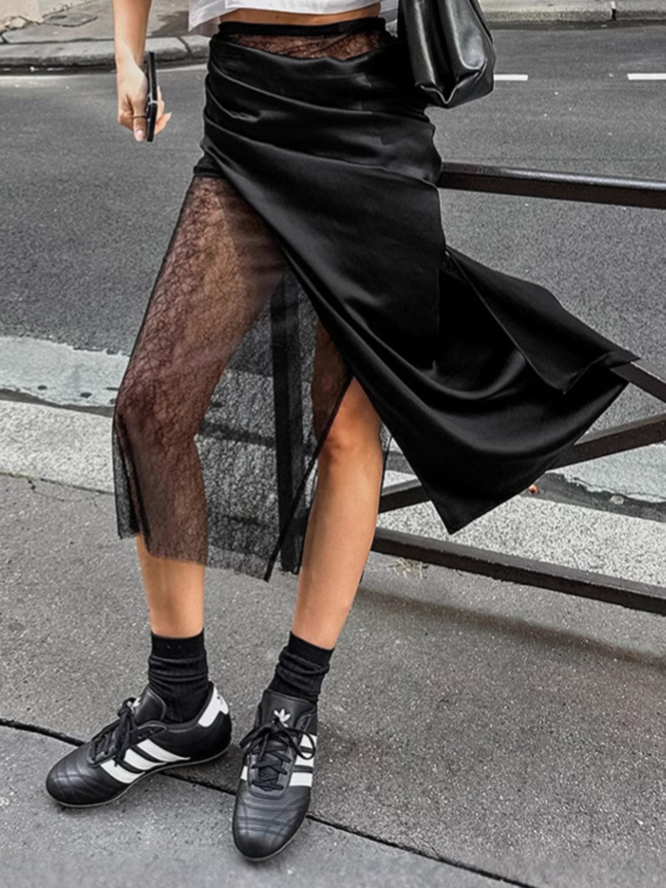 Women's elegant lace midi skirt by Trendsi featuring a sheer split detail, perfect for stylish and sophisticated looks.