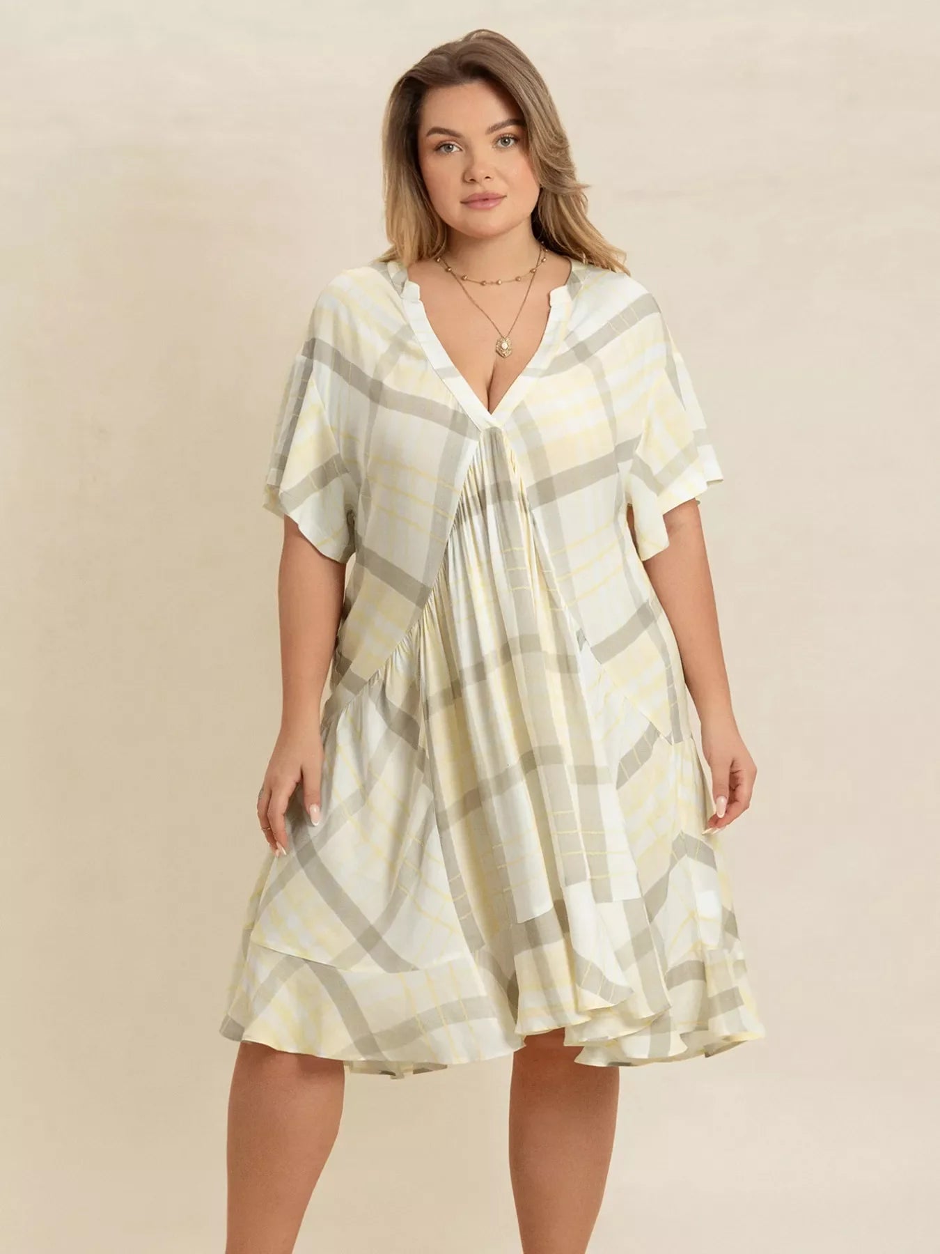 Plus size plaid flutter sleeve dress by Shopimist, featuring a stylish plaid pattern and flowing flutter sleeves.