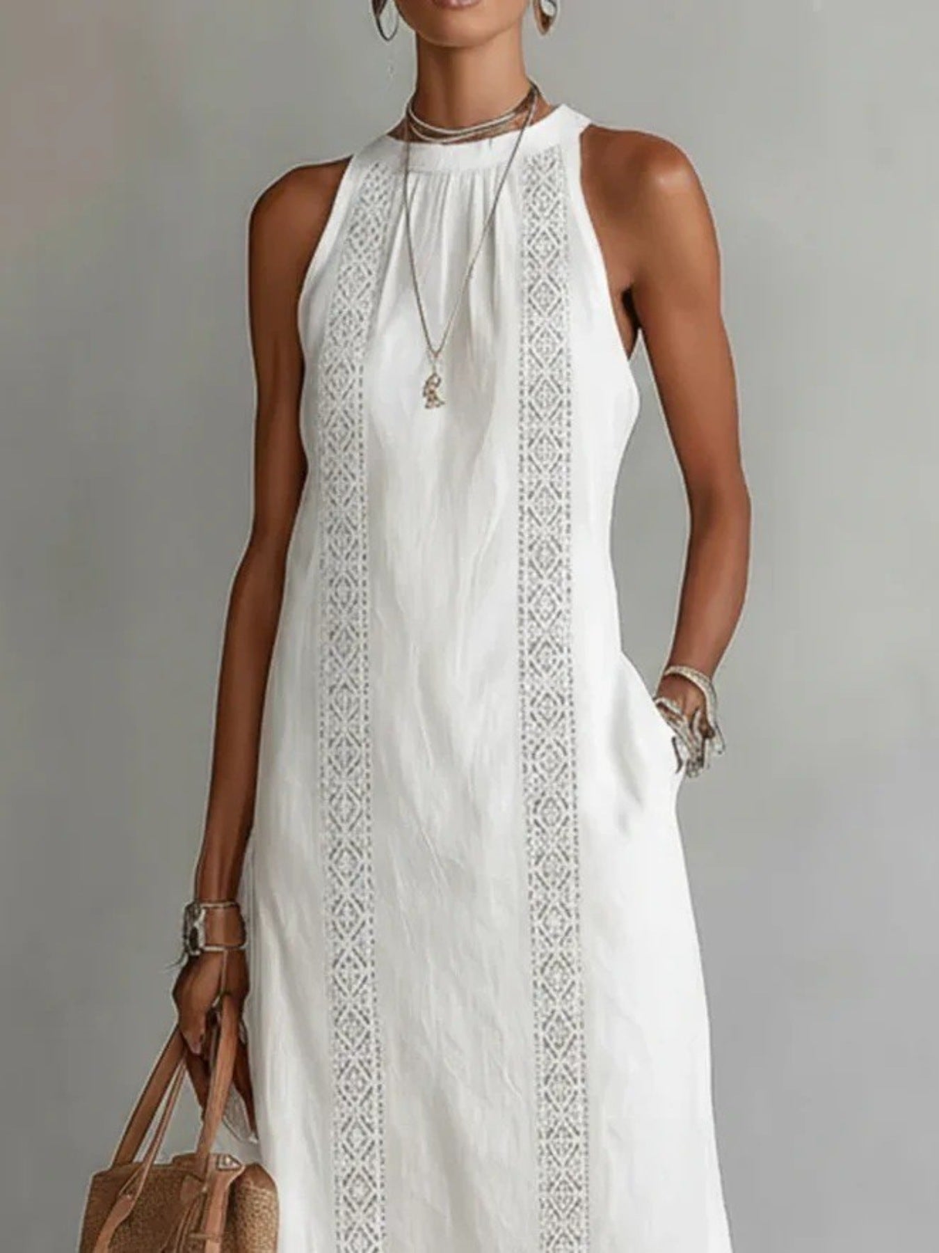 Sleeveless hollow-out midi dress from Plush Fashion Hub featuring side slit and pockets, displayed on a model.