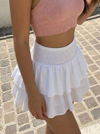 Smocked ruffled mini skirt by Trendsi featuring a flowy design and lightweight fabric, shown in a vibrant color.