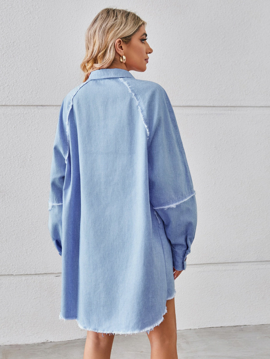 VYSN raw hem button-up denim dress displayed on a hanger, featuring classic collar and long sleeves, casual fashion style.