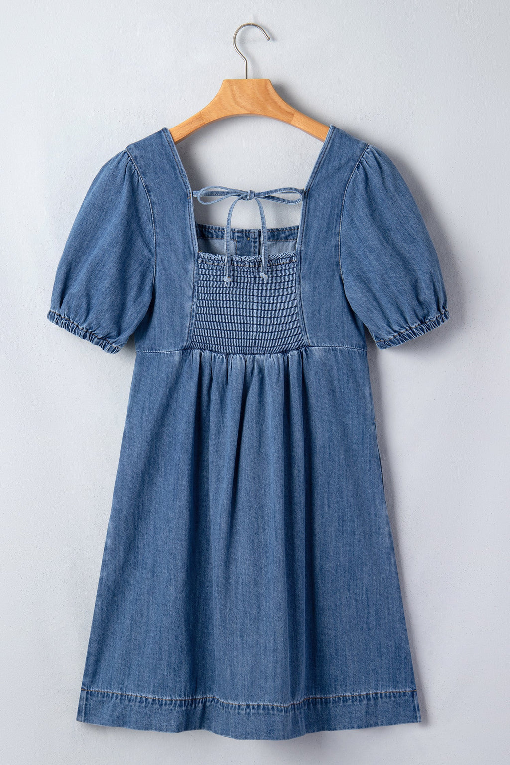 Threaded Pear Karina puff sleeve mini dress hanging on a mannequin, featuring a fitted bodice and stylish puff sleeves.