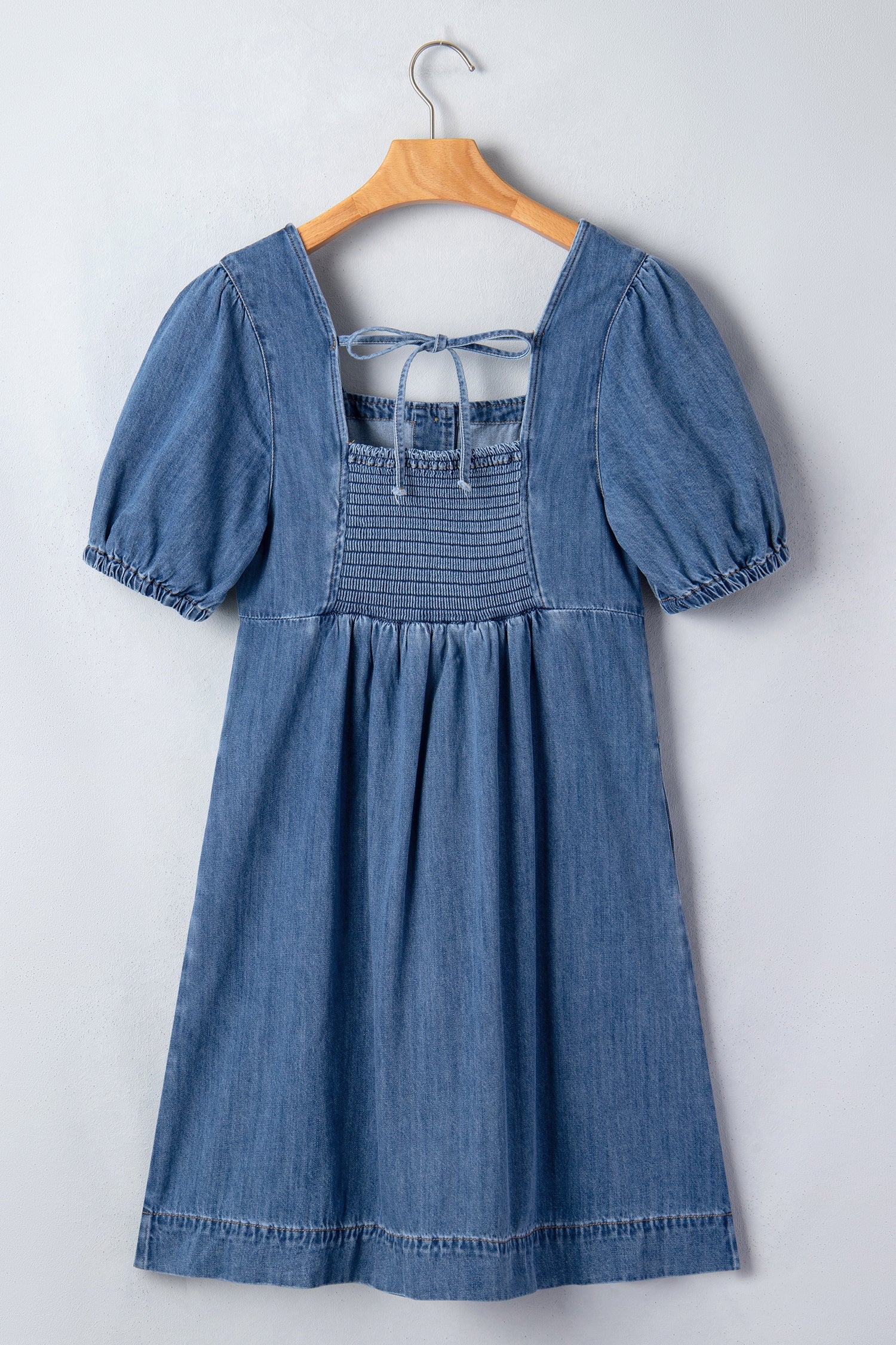 Threaded Pear Karina puff sleeve mini dress hanging on a mannequin, featuring a fitted bodice and stylish puff sleeves.