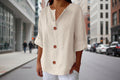 Women's V-neck buttoned blouse from FitiqueFit, casualwear style, shown in a light fabric with a relaxed fit and front button closure.