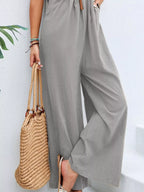 Plus size casual wide-leg overalls with pockets from Shopimist, featuring a relaxed fit and adjustable shoulder straps.